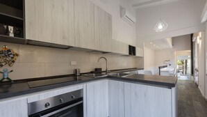 A modern kitchen with a built-in oven, a sink, and a countertop. - Vettori Hideaway by MMega Homes and Villas (Florence)
