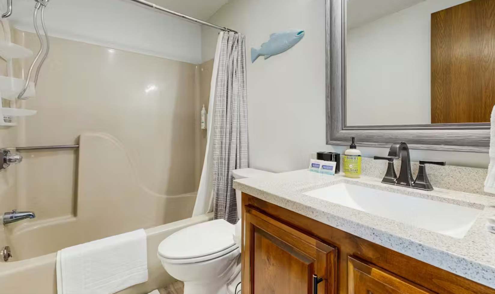 A bathroom with a bathtub, toilet, and sink.