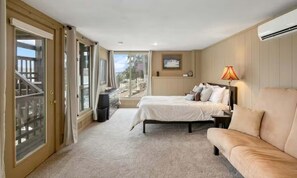 A bedroom with a bed, a sofa, a desk, and a window with a view. - Serene 5BR Lake House - LAKE VIEW - Gravois Mills (Gravois Mills)