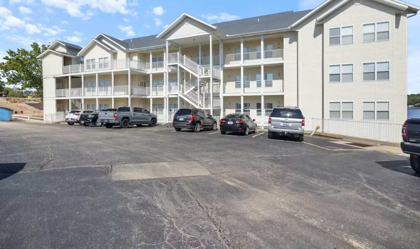 A multi-story motel with a parking lot.