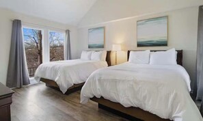 A hotel room with two beds, a large window with curtains, and two paintings on the wall. - Serene 3BR House - LAKE VIEW - Margaritaville (Osage Beach)