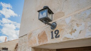 A building with a stone facade, a wooden door, and a number '12' sign. - Holiday Home 'Romo 1' with Mountain View (Chavida)