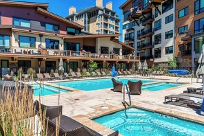 A hotel with a pool area, multiple balconies, and outdoor seating. - Lux Beaver Creek Escape | Views & Resort Amenities (Avon)