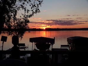 A lakeside view with a sunset, a dock, and a boat. - 3 bedroom Lakeside home, on Snowmobile & ATV trails. Pet friendly, onsite Dining (Phillips)