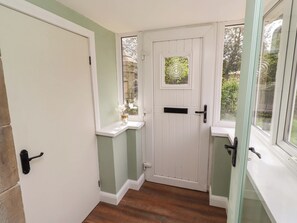 A white door with a glass panel, a small window, and a mailbox. - The Lodge (Alnwick)