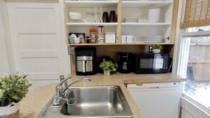 A kitchen with a stainless steel sink, a coffee maker, a microwave, and a dishwasher. - Suarez Art Stay, Coconut Grove, Sleeps 5, Park (Miami)