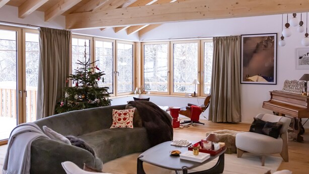 A spacious living room with a high wooden ceiling, a large window, a Christmas tree, a piano, and a cozy seating area. - La Tzoumaz Lodge, 4 Vallées luxury chalet, daily housekeeping, sleeps 10 to 12 (Riddes)