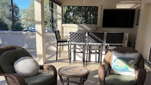 A covered patio area with wicker furniture, a grill, and a ceiling fan. - Luxury Golf Retreat w/pool in The Villages/Golf Cart Included/Prime Location (The Villages)