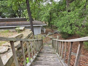A wooden staircase leading to a building with a sign that reads 'Welcome.' - Drift Away- 2-bedroom Lakefront house with Easy walk to Lake (Garfield)