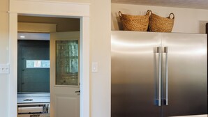 A modern kitchen with a stainless steel refrigerator, a built-in oven, and a microwave. - Wonderful 4-bedroom house with AC in charming Lafayette (Lafayette)