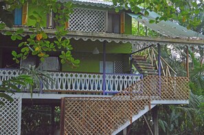 A two-story building with a balcony and a staircase. - Villa on the Caribbean Coast (Puerto Viejo de Talamanca)