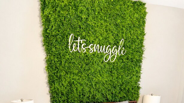 A bedroom with a green wall, a bed with white bedding, two bedside tables with lamps, and a wooden floor. - Muddy Boots HideoutI Cozy 2BR I 15m to RRG I Wi-Fi (Stanton)