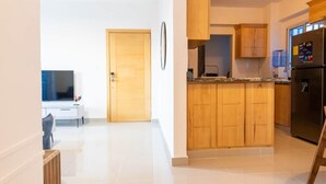 A modern kitchen with wooden cabinets, a built-in oven, and a refrigerator.