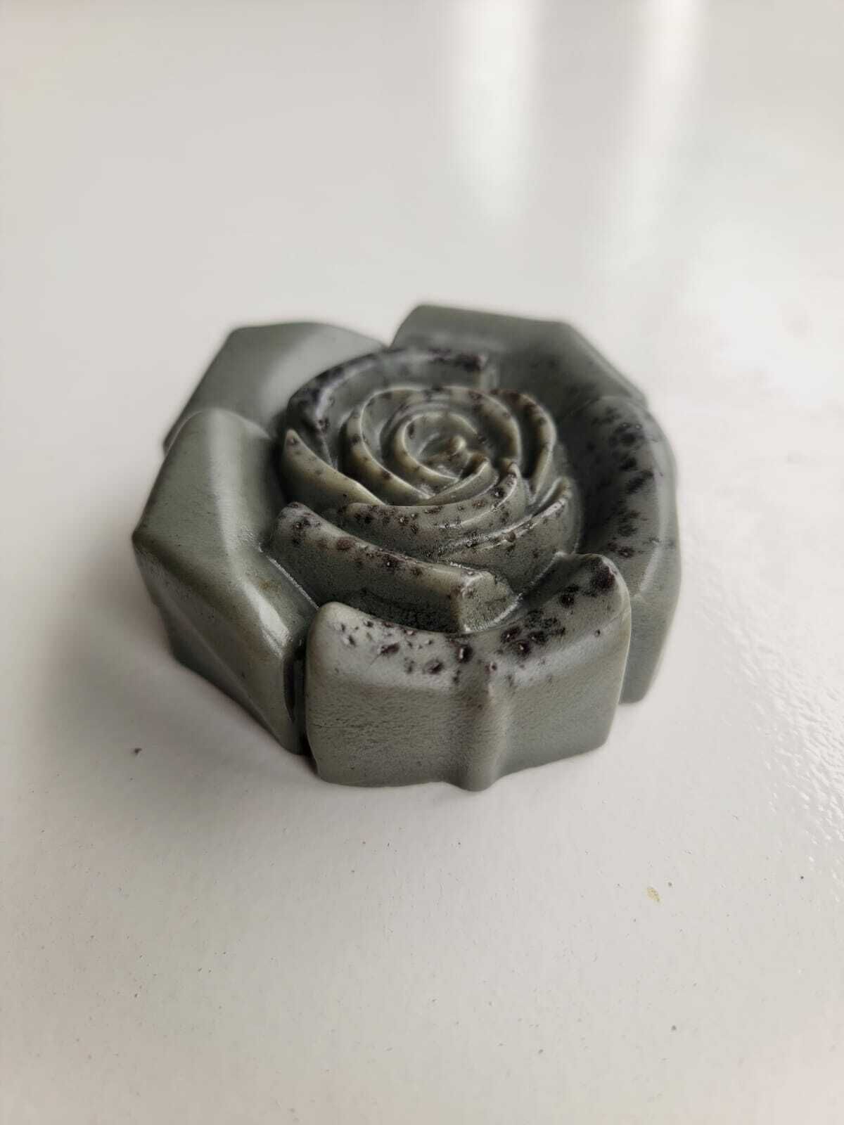 Una rosa con forma de objeto sobre una superficie lisa.