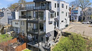 A multi-story residential building with balconies, a garage, and a driveway. - Luxury Mt Adams Retreat Suites (Cincinnati)