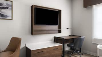 A modern office space with a desk, chair, and a mounted TV.