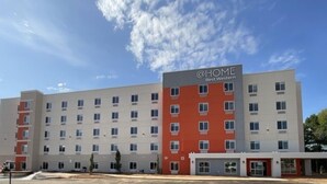 A multi-story hotel building with a sign reading 'Best Western.' - @HOME by Best Western McDonough Atlanta South (McDonough)