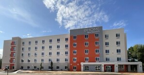 A multi-story hotel building with a sign reading 'Best Western.' - @HOME by Best Western McDonough Atlanta South (McDonough)