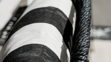 A close-up of a black and white striped fabric, possibly a part of a piece of furniture or decor.