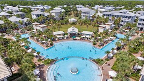 Un complexe hôtelier doté de plusieurs piscines, de palmiers et de bâtiments de style hôtelier.