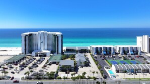 A coastal hotel with a parking lot, a tennis court, and a view of the ocean. - Gulf View Oasis and Beach Chairs (Panama)