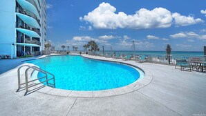 A swimming pool with a curved edge, a metal handrail, and a sign indicating shoes are required. - Gulf View Oasis and Beach Chairs (Panama)