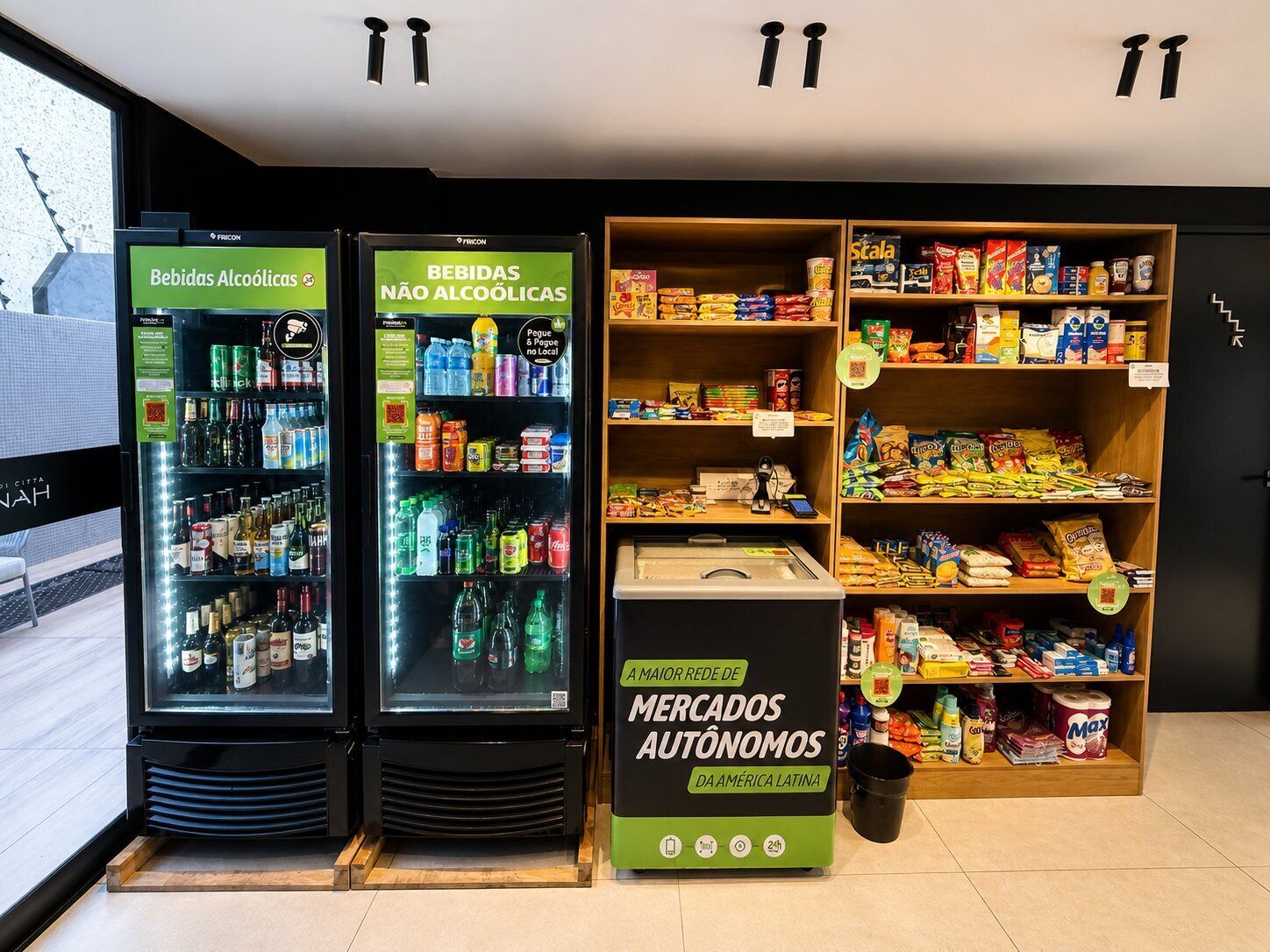 Two beverage vending machines, a snack shelf, and a self-service kiosk in a store.