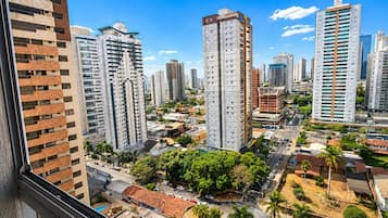 A high-rise building with a modern design, surrounded by other tall buildings, indicating a dense urban area.
