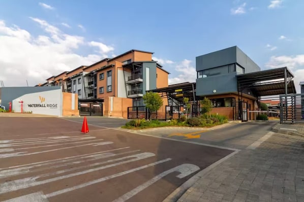 A modern building with a sign reading 'Waterfall Ridge.' - Waterfall Hive (Midrand)