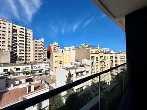 A high-rise building with multiple balconies and satellite dishes, viewed from a window with a clear sky. - Gauthier luxury studio (Casablanca)