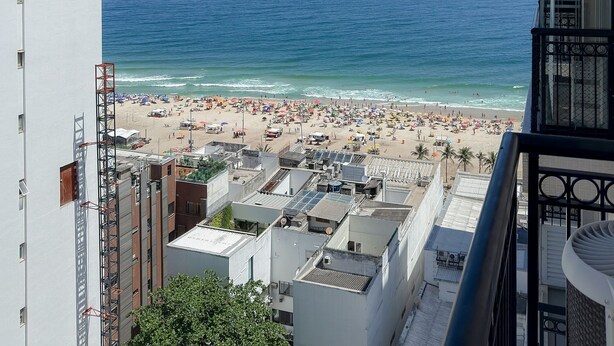 A high-rise building with a view of a beach and the sea. - Ipanema 2 Suites Ocean View 1min to Beach (Rio de Janeiro)