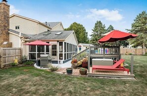 A backyard with a covered patio, a slide, and a barbecue area. - The Emerald Escape with 4 bedrooms 2 baths (Dublin)