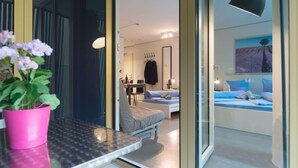 A modern bedroom with a bed, a desk, and a chair. There is a potted plant on the desk. - LU Gletschergarten II-Allmend HITrental Apartment by Interhome (Lucerne)