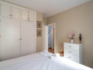 A bedroom with a bed, a dresser, and a wardrobe. - Bajamar Nerja II 7 by Casasol by Interhome (Nerja)
