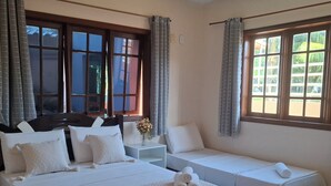 A hotel room with two beds, a nightstand, and a window with curtains. - Mestre Lord aparthotel by La Vem Ferias  (Porto Seguro)