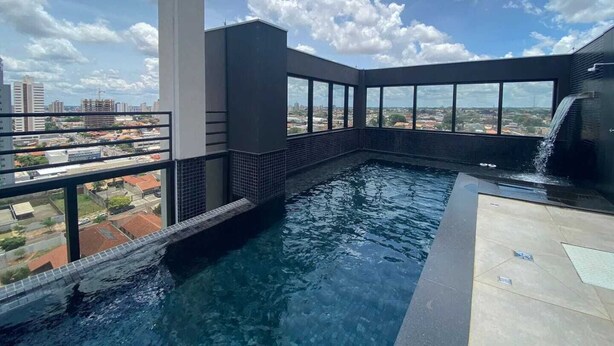A rooftop infinity pool with a city view, a water feature, and a tiled deck. - Cozy Apartment - Prime Building (Campo Grande)