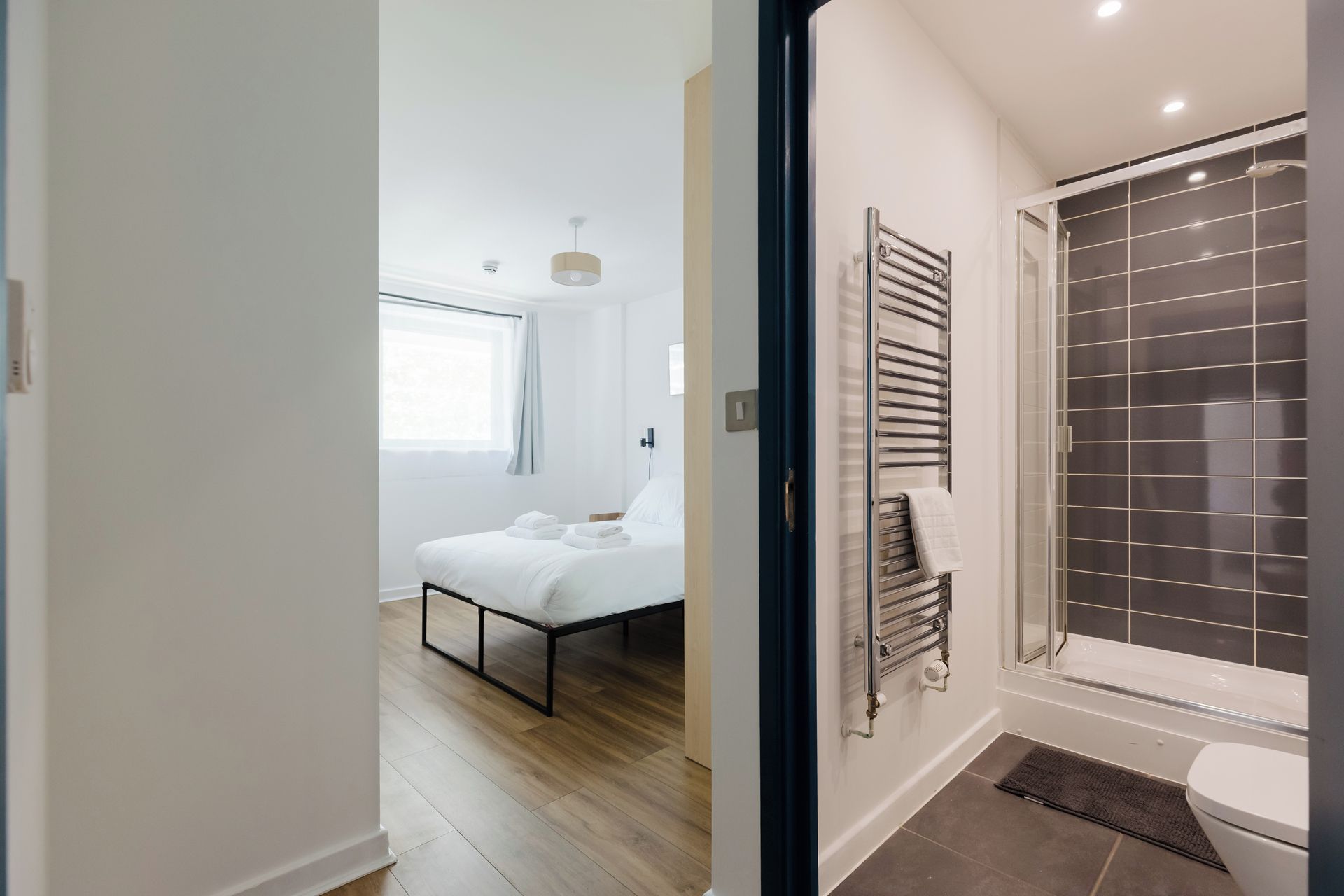A modern bathroom with a glass shower enclosure and a toilet.