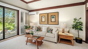 A living room with a sofa, coffee table, side table, and a potted plant. - Kiahuna Plantation Resort 58 Royal Garden 1 BD (Koloa)