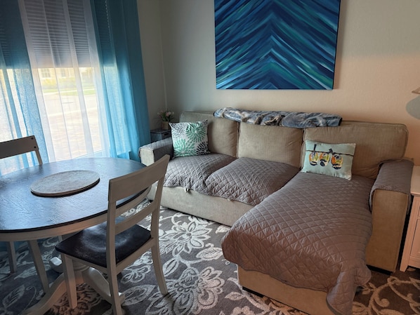 A room with a bed, a table, and a chair.