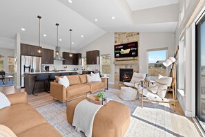 A modern living room with a sofa, ottoman, and a coffee table. - Eden's Basecamp |Hot Tub |Firepit | Kayaks & Bikes (Eden)