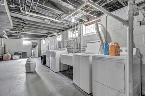 A laundry facility with industrial equipment, large washing machines, and cleaning supplies. - Pet-Friendly Home - Sleeps 6 - Walkable Lakewood (Lakewood)