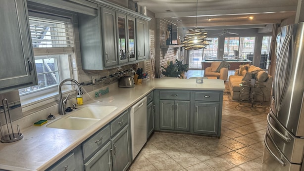 A kitchen with a sink, stove, cabinets, and a refrigerator. - Inlet Life -Private Dock/Pool- (Murrells Inlet)
