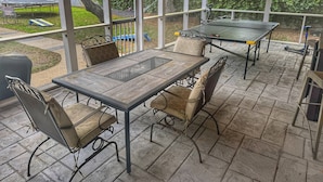 An outdoor patio with a table and chairs, a pergola, and a view of the surrounding area. - Inlet Life -Private Dock/Pool- (Murrells Inlet)