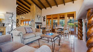 A cozy living area with a sofa, coffee table, and dining set. - Adobe Village Inn Painted Desert (Sedona)