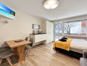 A modern bedroom with a bed, a desk, and a chair. - Studio Phoenix - Zermatt by Interhome (Zermatt)
