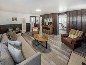 A living room with a sofa, chairs, a coffee table, and a fireplace. - Eagle Point Walk to Lake & Hot Tub (Big Bear Lake)