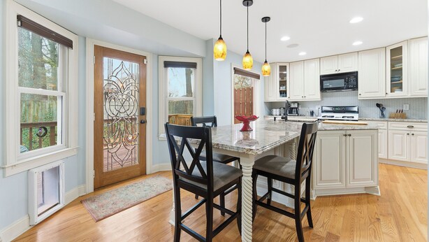 A kitchen with white cabinets, a marble countertop, and pendant lighting. - 3-bedroom Comfy Townhome, less than 10 min from the Battery, Bring the Family (Marietta)