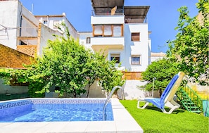A residential building with a swimming pool, a covered outdoor area, and a green lawn. - Stunning home in Prado del Rey (prado del Rey)