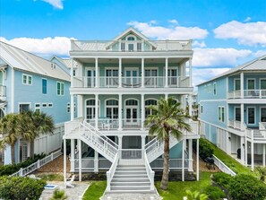A multi-story building with a central staircase, balconies, and a symmetrical facade.