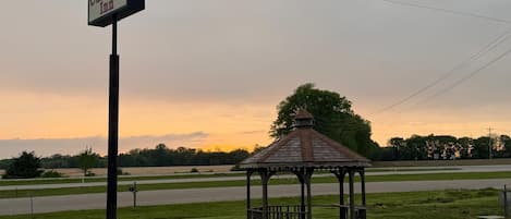 A gazebo with a sign for 'Carlisle Inn' in a grassy area.